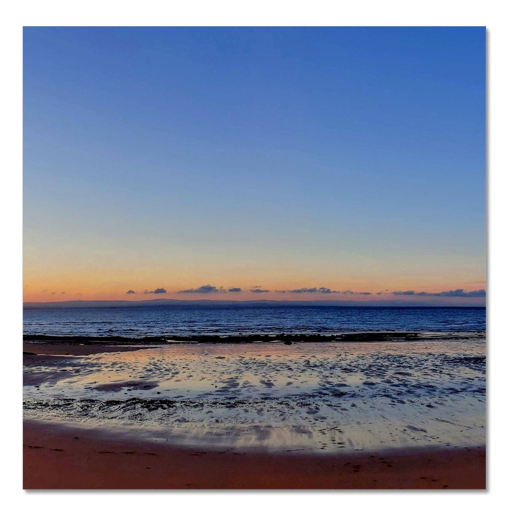 Central shoreline at Ellie to Earlsferry in Fife, showing calm sea, distant horizon and soft dawn light, forming the second panel of a panoramic coastal photograph.