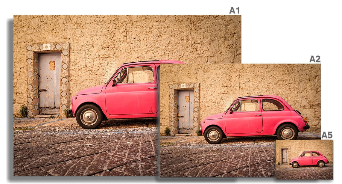Pink vintage Fiat 500 parked beside a tiled doorway on a  Sun worn Italian street – La Cinquecento Rosa by Scotland in Frame