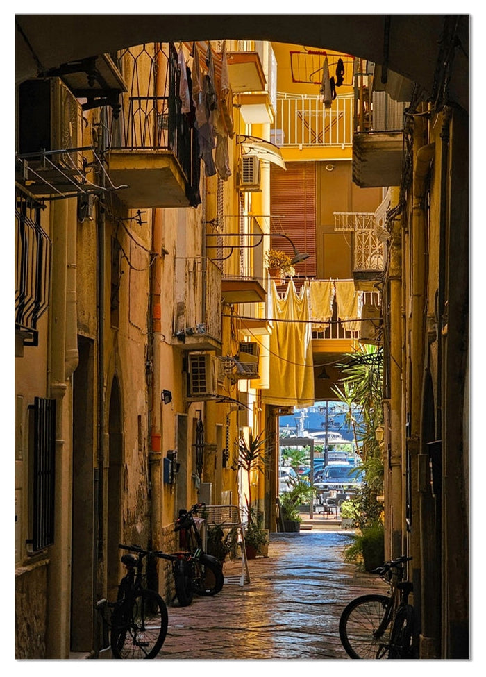 Verso il Mare fine art photograph looking along a narrow Italian street towards the sea, framed by balconies and bicycles